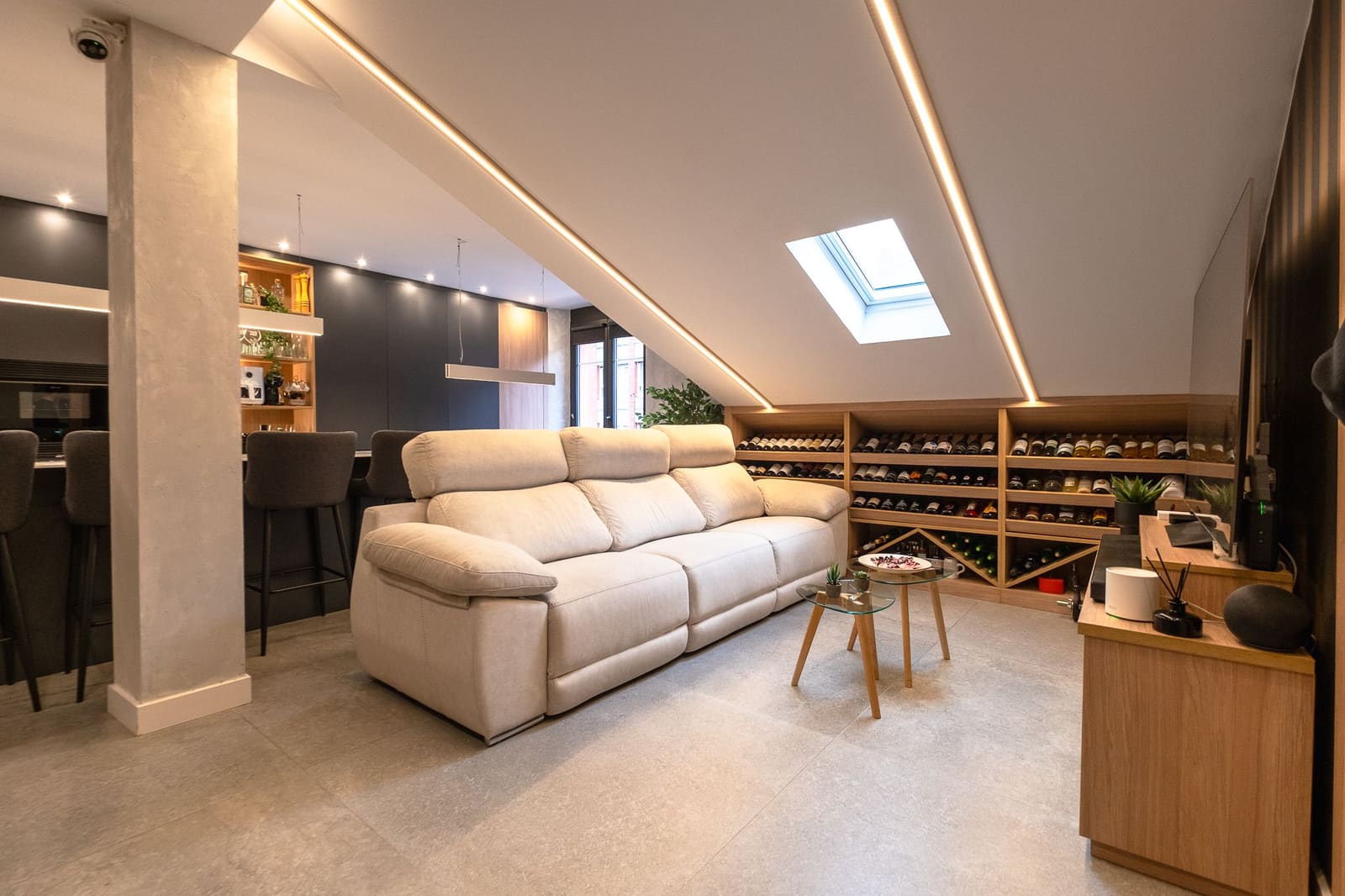 Living room under a pitched roof with a skylight in a high-end remodel